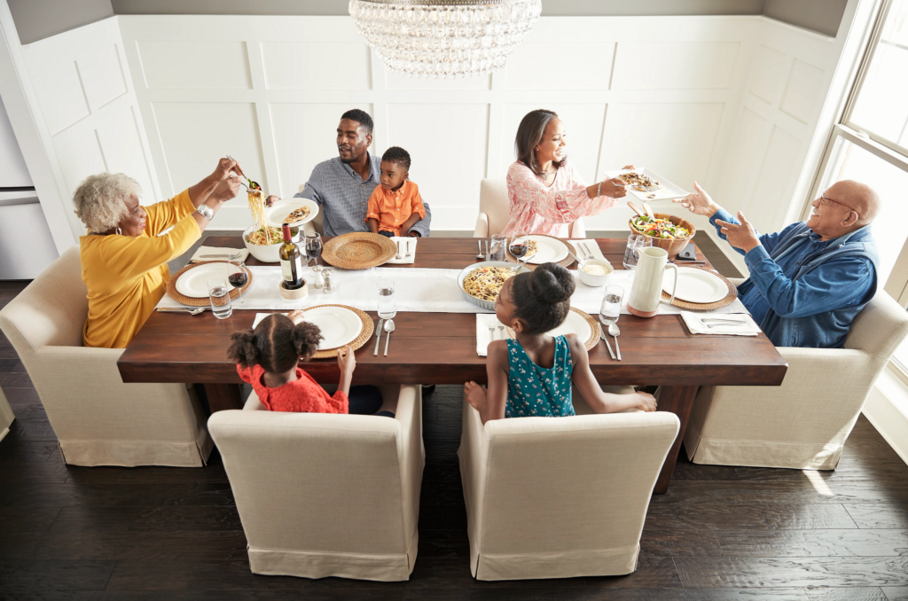 Family enjoying food in dining room | Nampa Floors