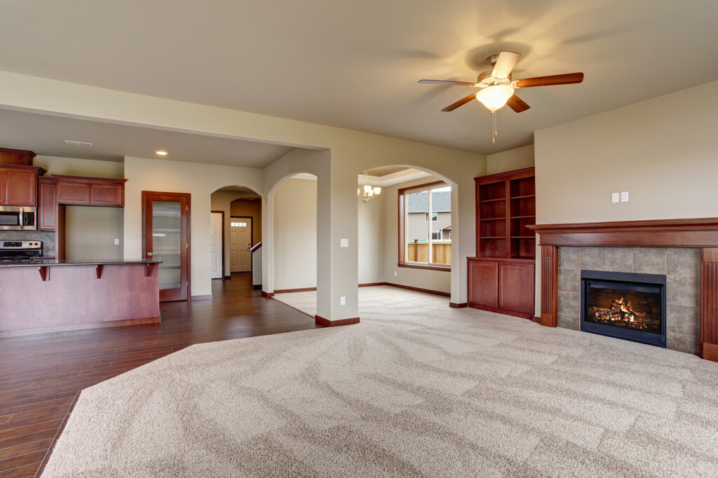 Carpet Flooring in a large living room opening into the kitchen by Nampa Floors Boise, ID Nampa, ID.